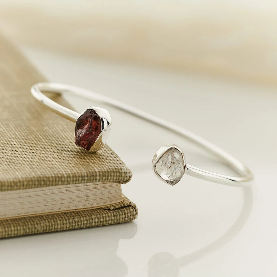 Open silver cuff with raw garnet and Herkimer diamond ends
