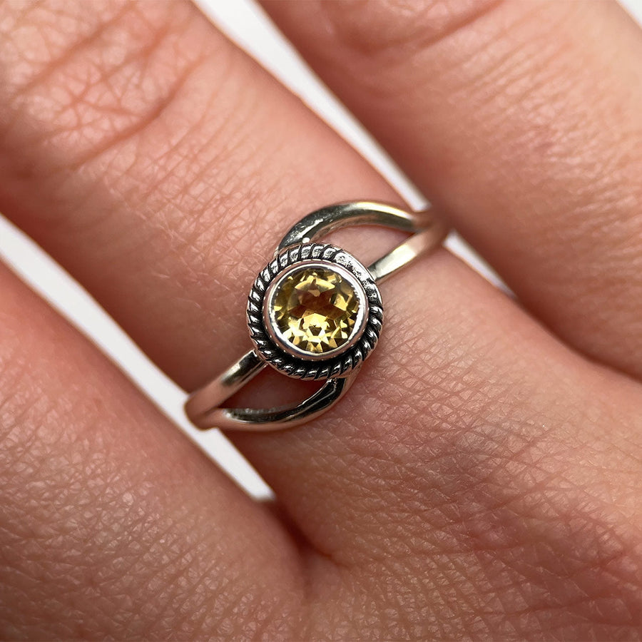 Citrine infinity ring in sterling silver with a rope-edge bezel, worn